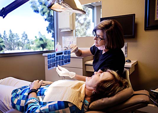staff member showing patient his x-rays